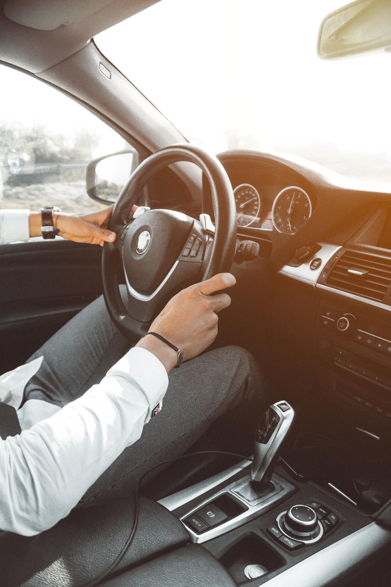 Smart businessman driving a luxurious company car